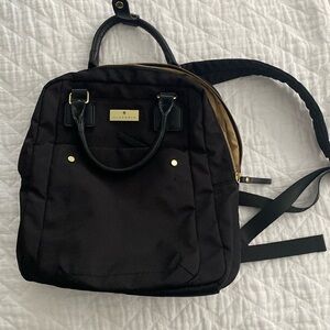 Black backpack with multiple pockets, luggage handle sleeve